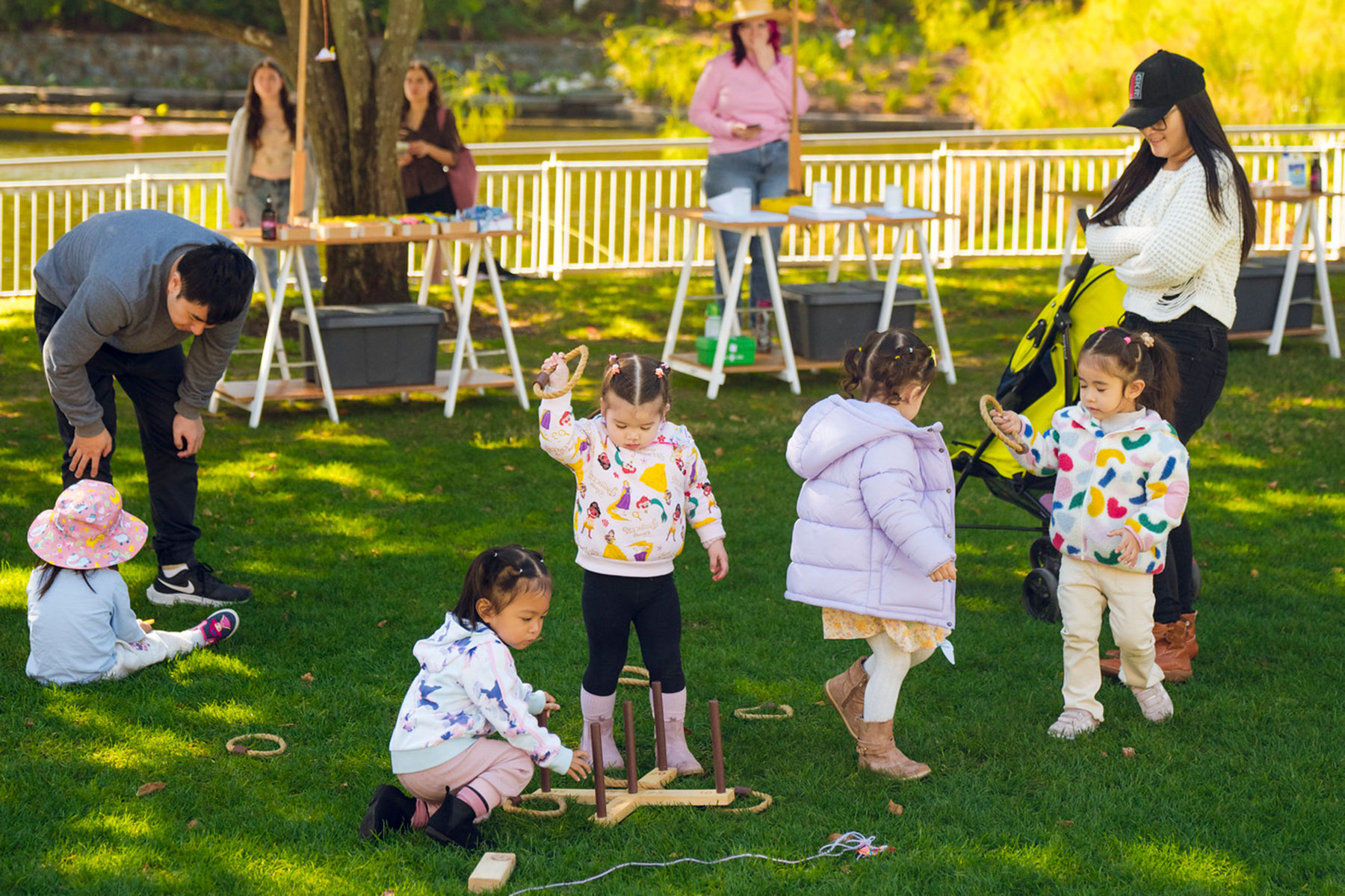 Kids playing with toys outdoors on a grassed area