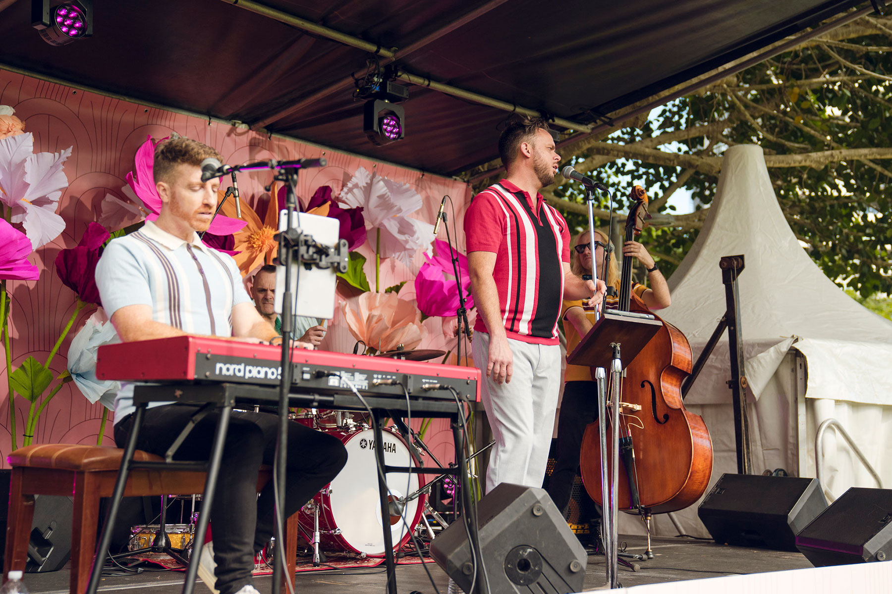 Members of the band SCAT performing on the main stage at Providore Park